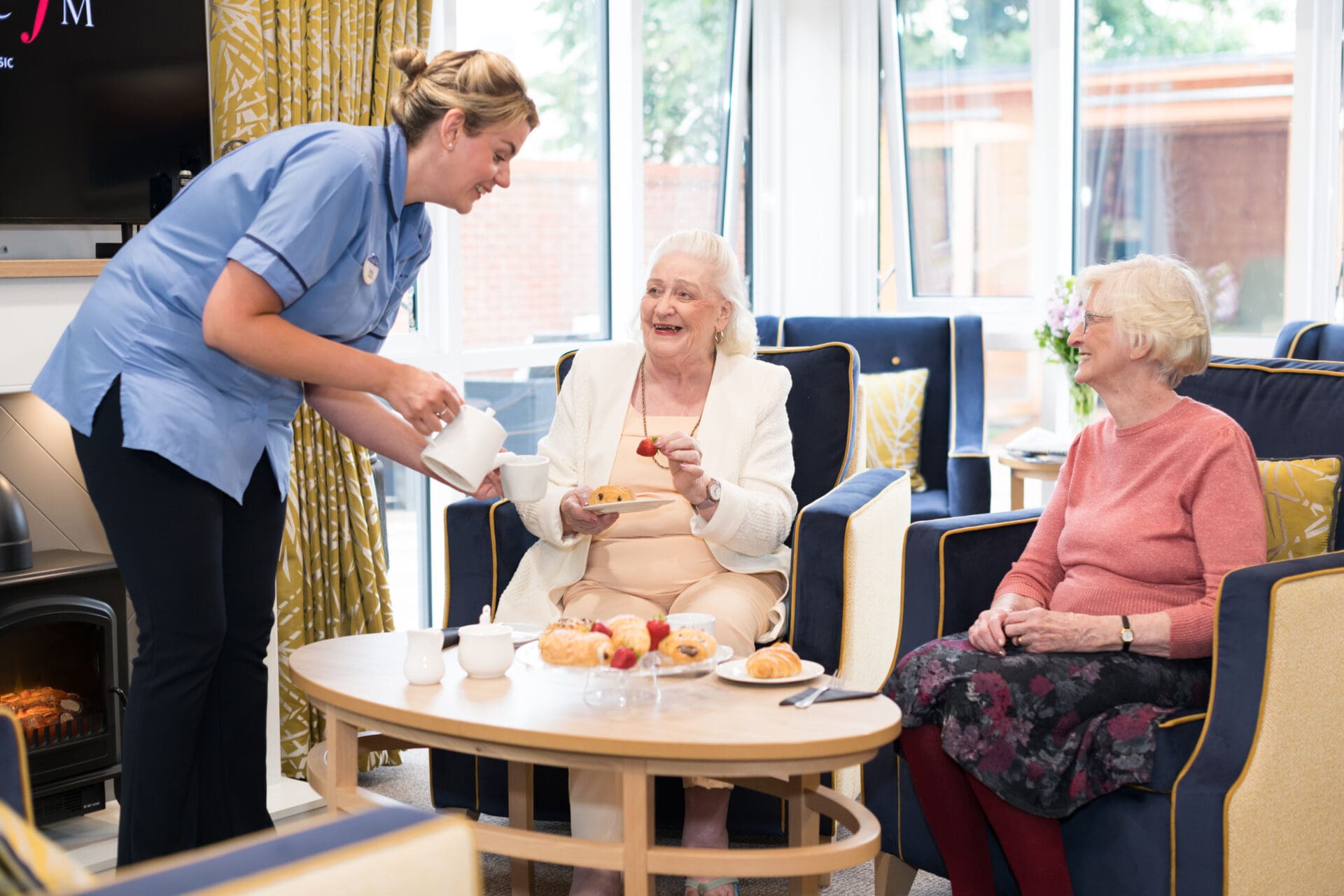 socialising in the lounge at Cinnamon Care Collection