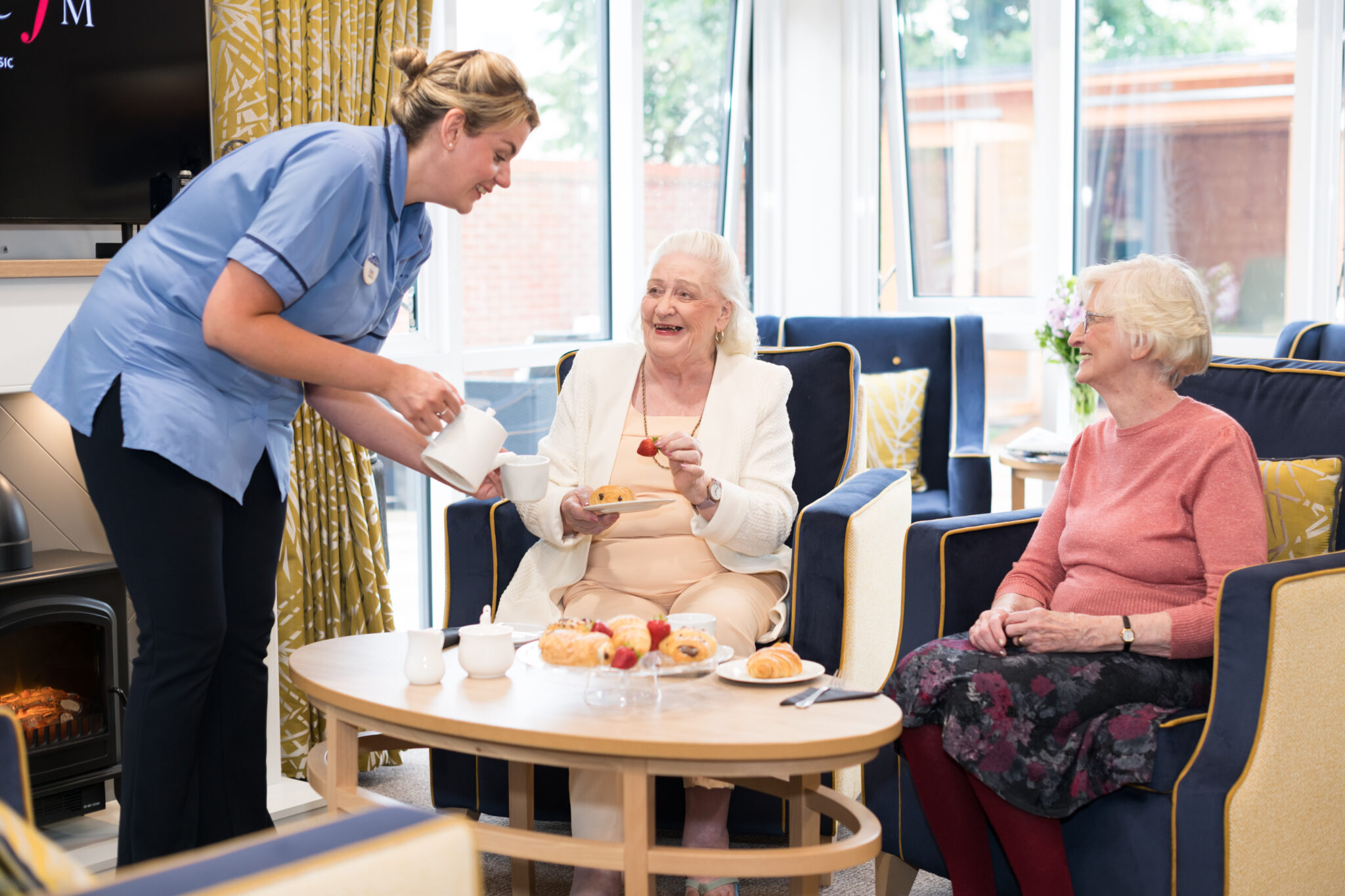 socialising in the lounge at Cinnamon Care Collection