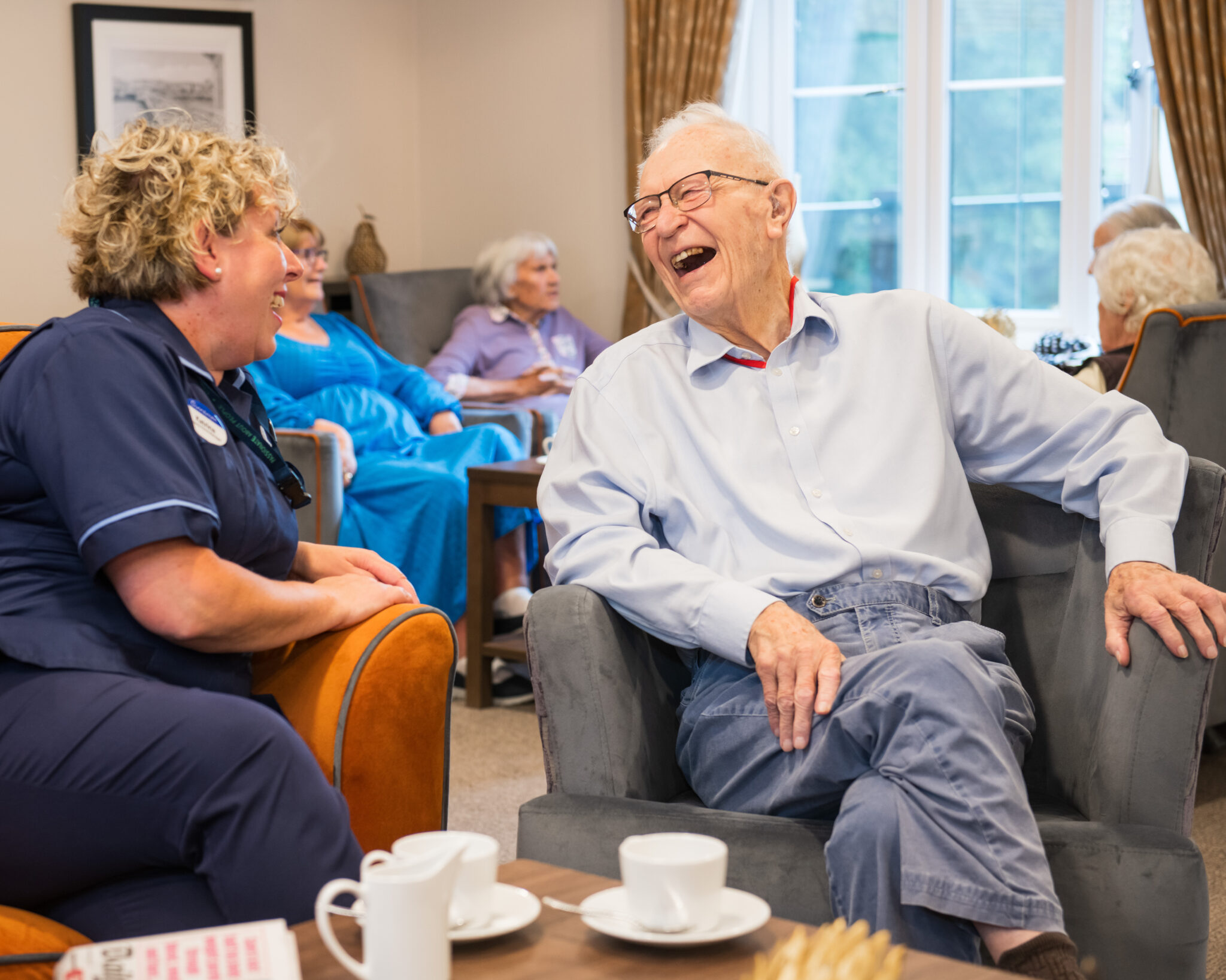 socialising in the lounge at Cinnamon Care Collection
