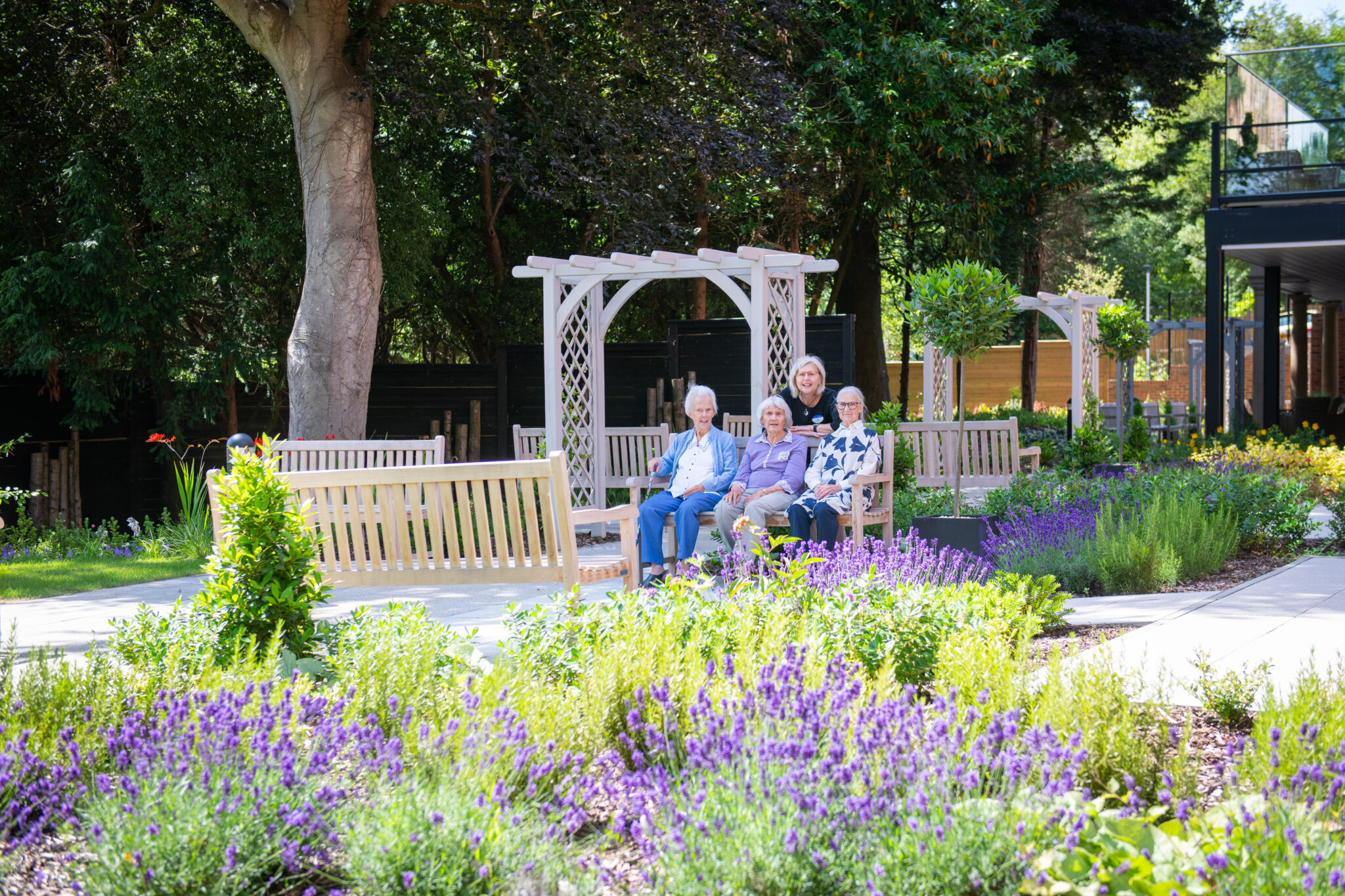 residentis socialising in the picturesque gardens Cinnamon Care Collection