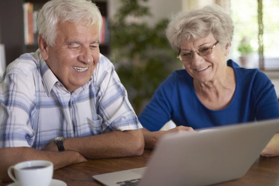 elderly couple using digital technology